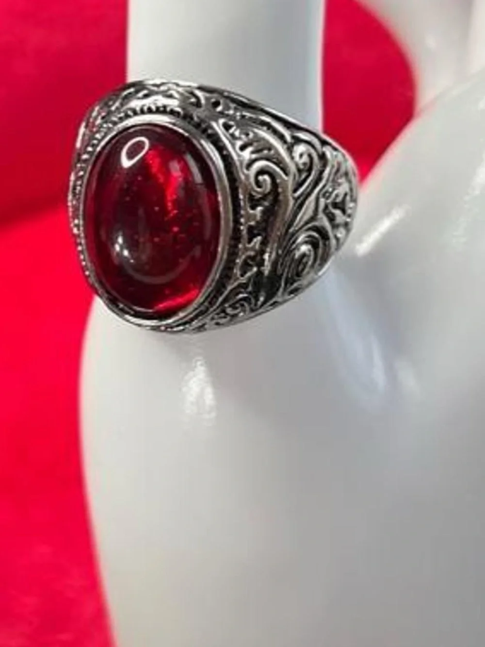 Red ruby gemstone ring with silver filigree detailing